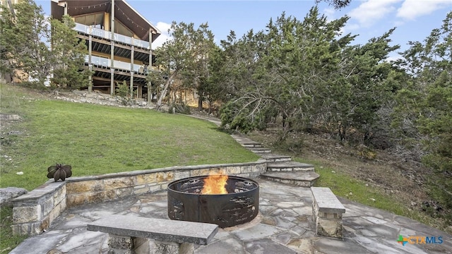 exterior space featuring a patio and a fire pit