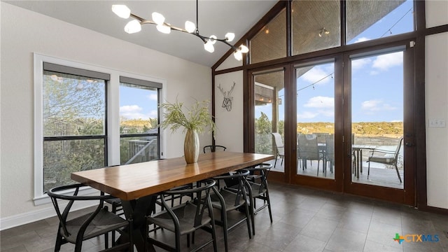 dining room featuring vaulted ceiling and an inviting chandelier