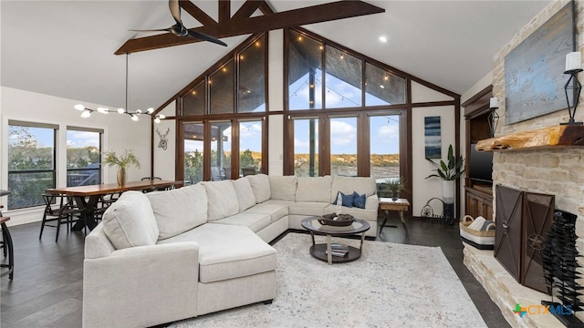 living room with a stone fireplace, ceiling fan, high vaulted ceiling, and wood-type flooring