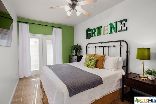 tiled bedroom with a ceiling fan and baseboards