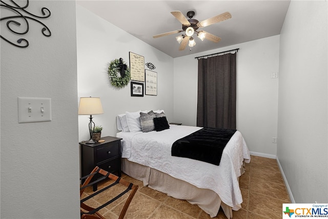 tiled bedroom with baseboards and a ceiling fan