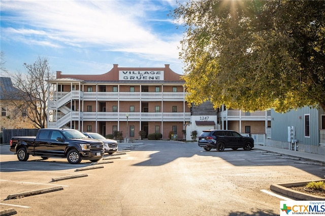 view of building exterior featuring uncovered parking