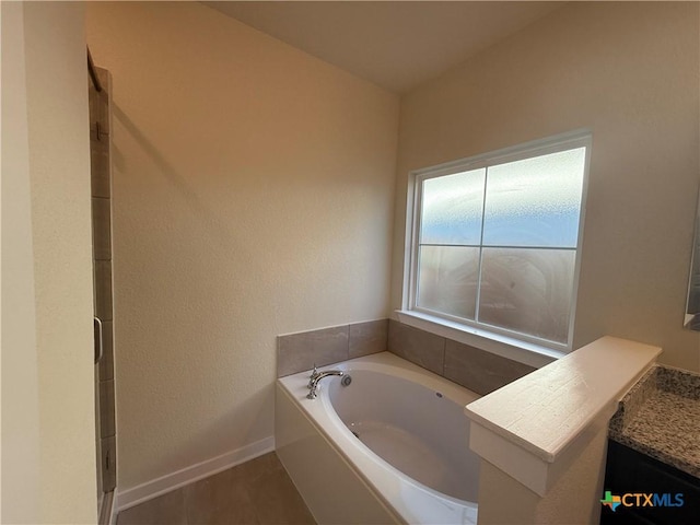 bathroom with vanity and a tub