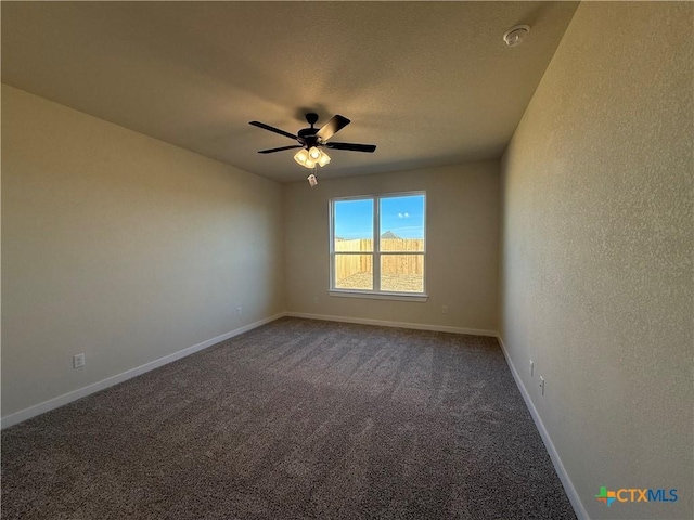 carpeted spare room featuring a textured ceiling and ceiling fan