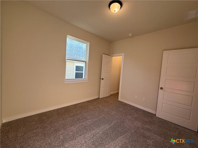 unfurnished bedroom featuring dark colored carpet