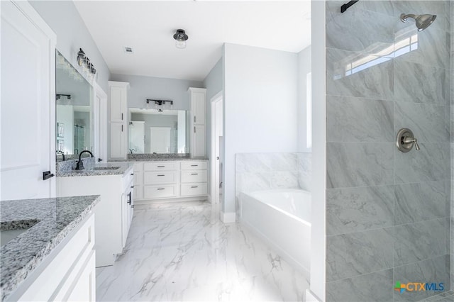 bathroom featuring vanity and shower with separate bathtub