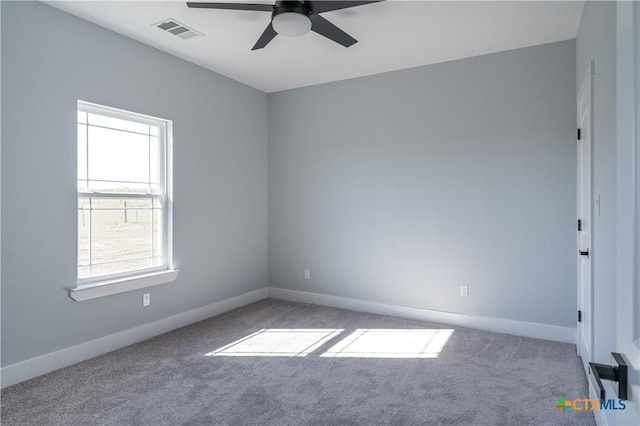 carpeted empty room featuring ceiling fan