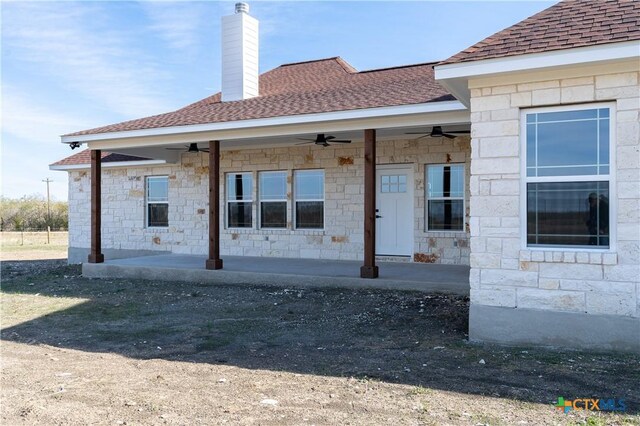 back of property featuring ceiling fan