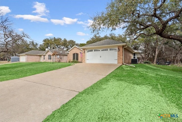 ranch-style house with a garage, a front lawn, and central air condition unit