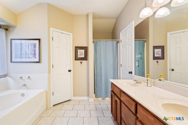 bathroom featuring vanity, tile patterned floors, and a tub