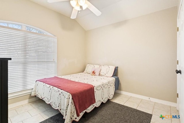 tiled bedroom with lofted ceiling and ceiling fan