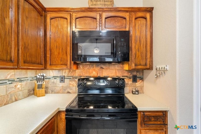 kitchen featuring tasteful backsplash and black appliances