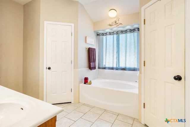 bathroom featuring vanity, a bath, and tile patterned flooring