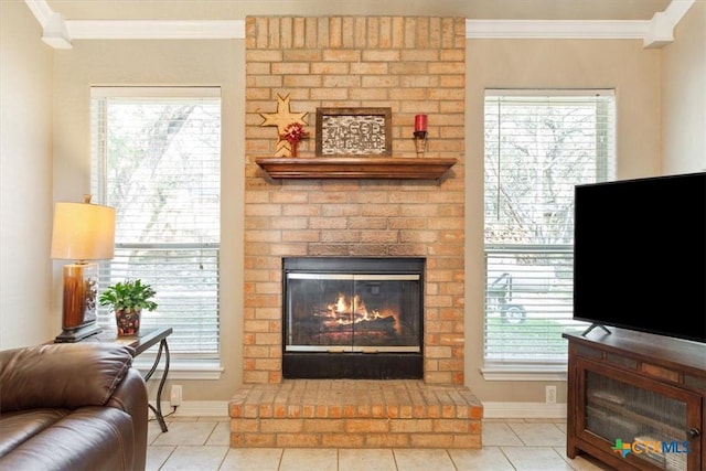 tiled living room featuring crown molding, a healthy amount of sunlight, and a fireplace