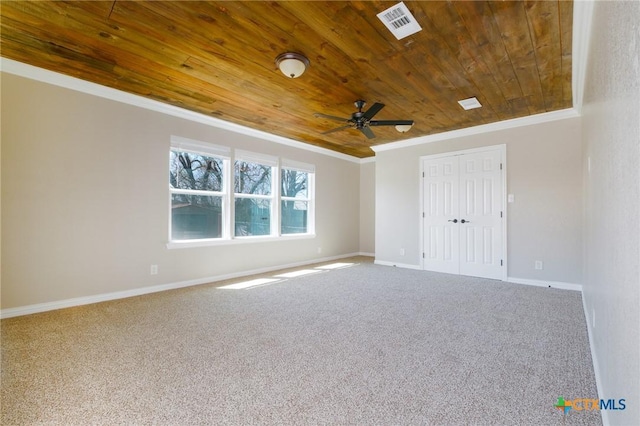 carpeted spare room featuring visible vents, wood ceiling, crown molding, and ceiling fan