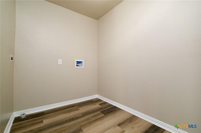 laundry room with dark wood finished floors, laundry area, hookup for a washing machine, and baseboards