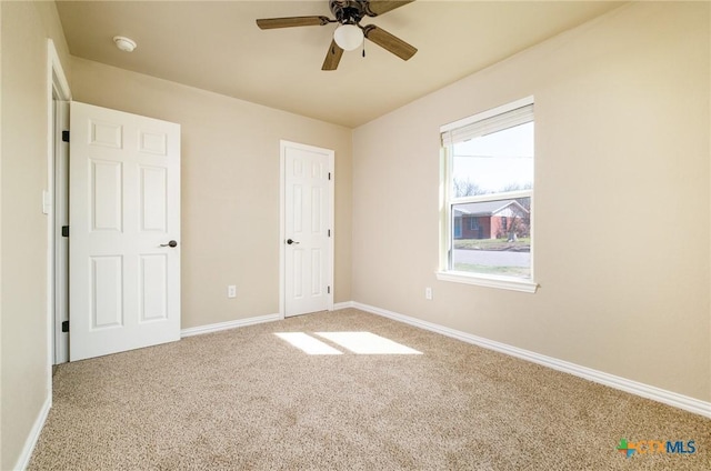 unfurnished bedroom featuring baseboards, carpet, and ceiling fan