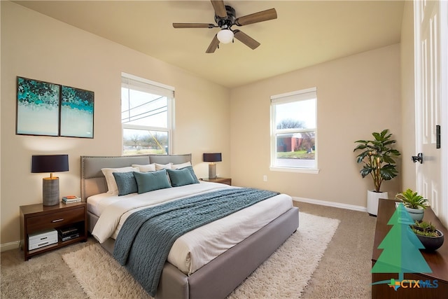 carpeted bedroom featuring a ceiling fan and baseboards