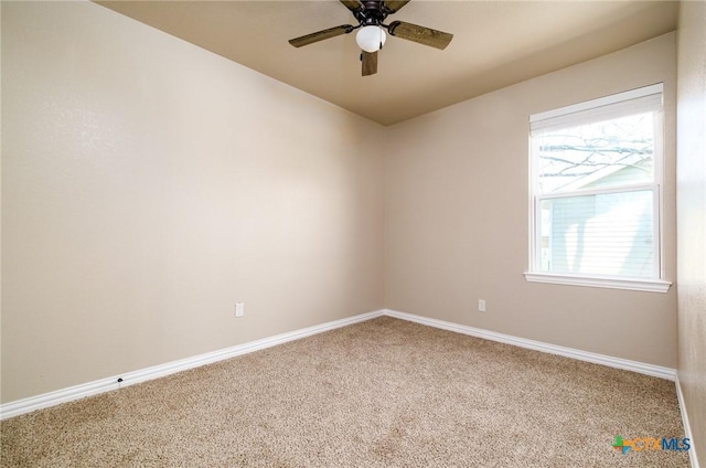 spare room with baseboards, ceiling fan, and carpet flooring