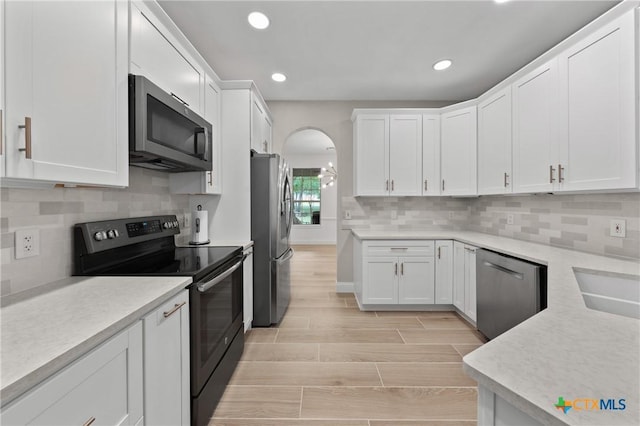 kitchen with white cabinets, stainless steel appliances, and light countertops