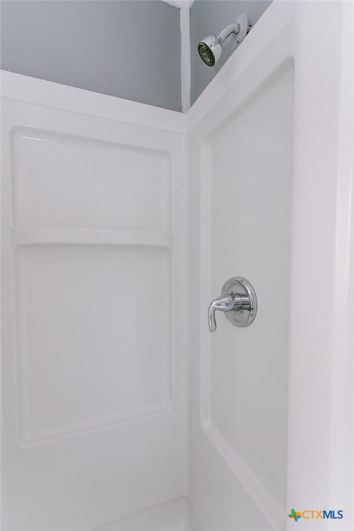 interior details featuring a shower