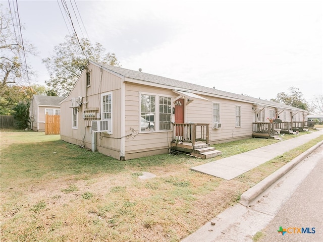 view of front facade with a front yard and cooling unit