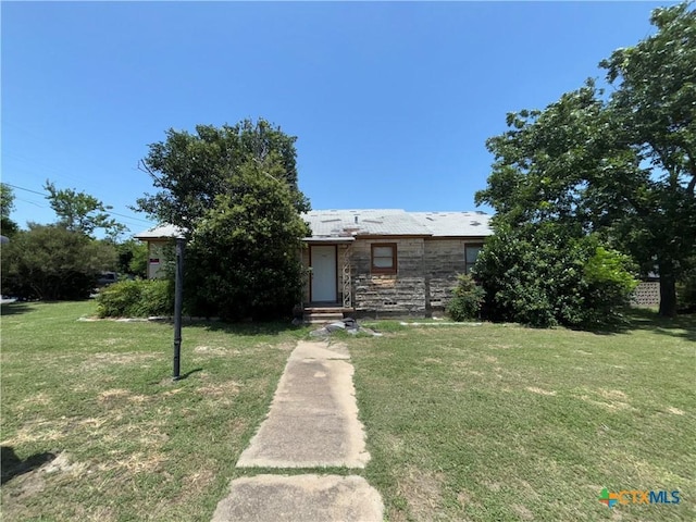 1702 E Heritage Ave, Temple, TX 76501 - obstructed view of property featuring stone siding and a front yard