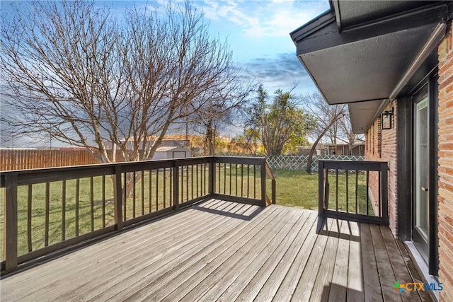 wooden terrace with a fenced backyard and a yard