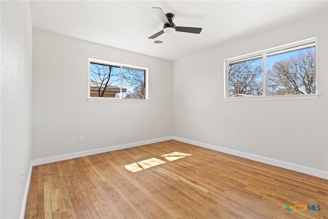 unfurnished bedroom featuring visible vents, a ceiling fan, hardwood / wood-style flooring, and baseboards