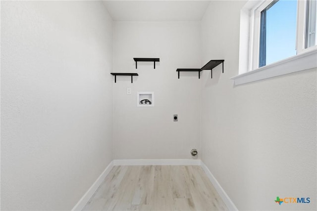 clothes washing area with baseboards, laundry area, washer hookup, and hookup for an electric dryer