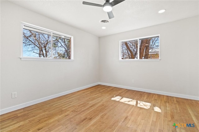 interior space featuring a healthy amount of sunlight, light wood finished floors, and baseboards