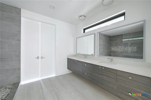 bathroom featuring vanity and tiled shower