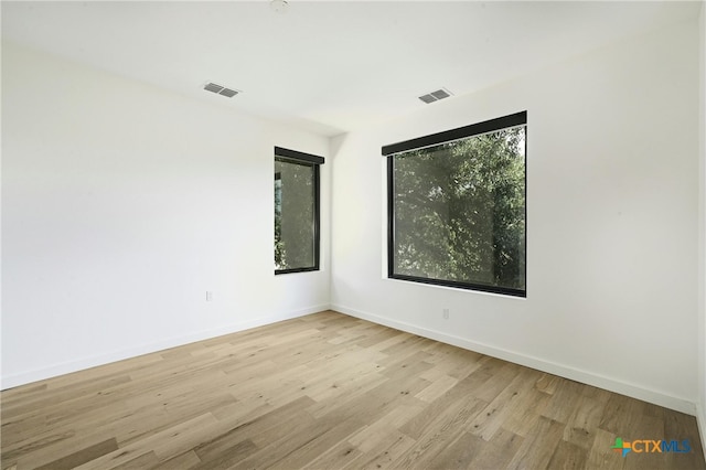 unfurnished room with light hardwood / wood-style flooring