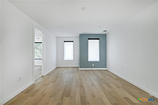 unfurnished room with light wood-type flooring