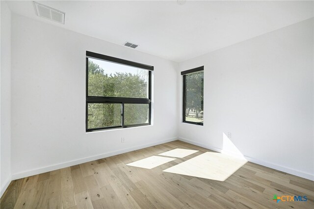 spare room featuring light hardwood / wood-style floors