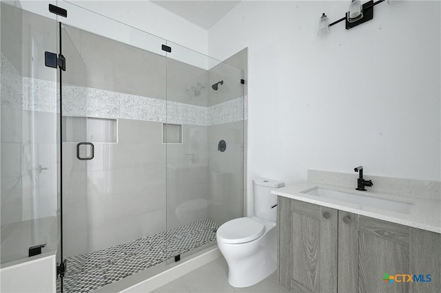 bathroom with walk in shower, tile patterned flooring, vanity, and toilet