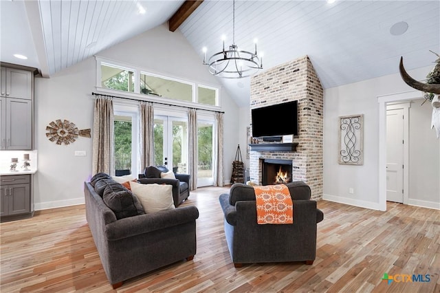 living room with high vaulted ceiling, a fireplace, light hardwood / wood-style flooring, beam ceiling, and french doors