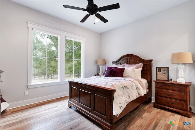 bedroom with ceiling fan and light hardwood / wood-style floors