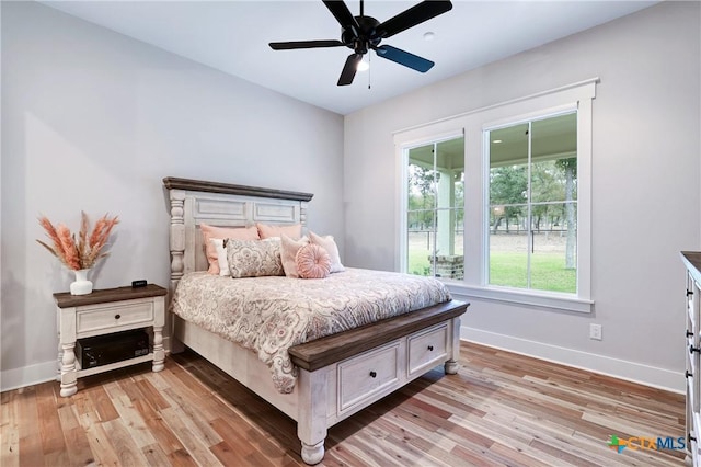 bedroom with light hardwood / wood-style flooring and ceiling fan