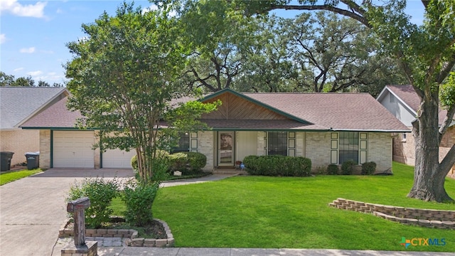 2711 Oak Leigh St, San Antonio, TX 78232 - view of front of house with concrete driveway, a front lawn, a garage, brick siding, and a shingled roof