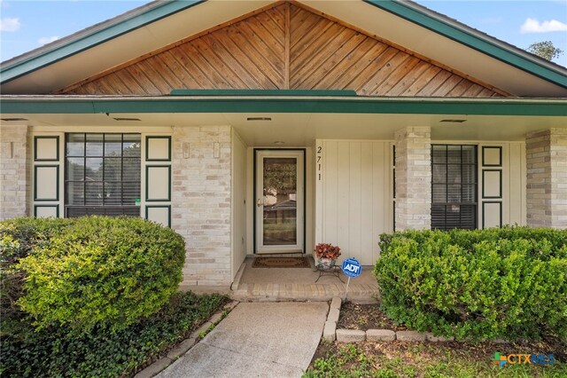 2711 Oak Leigh St, San Antonio, TX 78232 - view of exterior entry featuring covered porch and brick siding