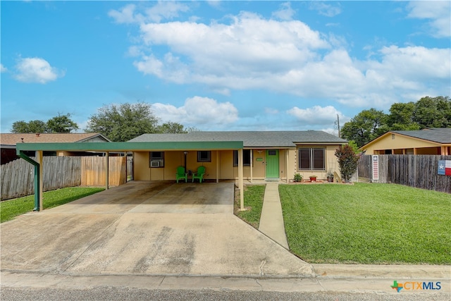 ranch-style home with a front yard and a carport