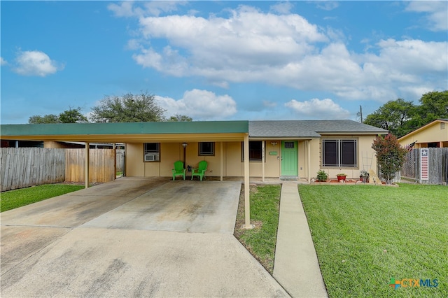 ranch-style house with a front yard and a carport