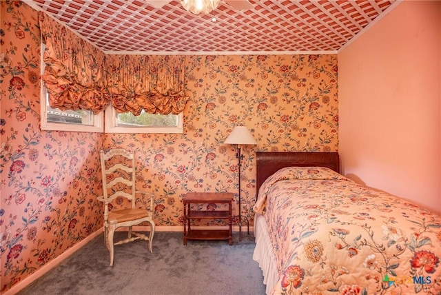 unfurnished bedroom featuring baseboards, carpet floors, and wallpapered walls