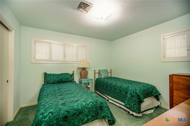carpeted bedroom with baseboards and visible vents