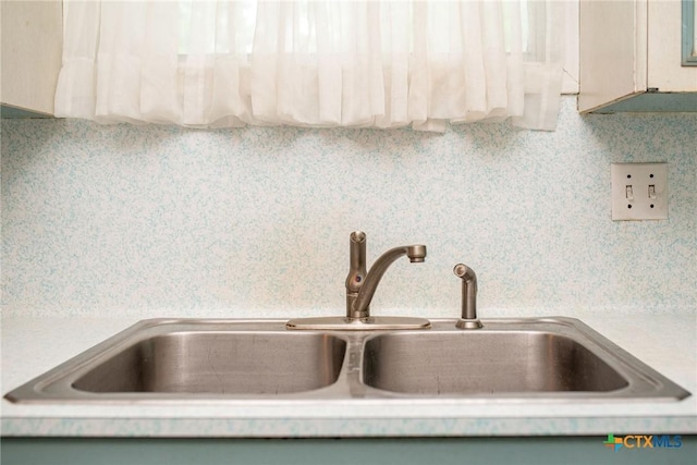 interior details featuring light countertops and a sink