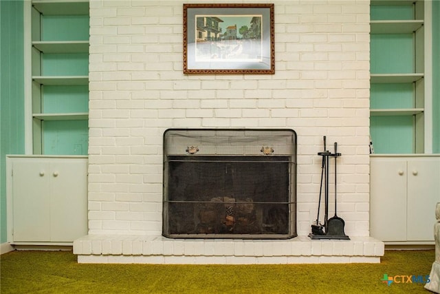 details with built in features, carpet floors, and a brick fireplace