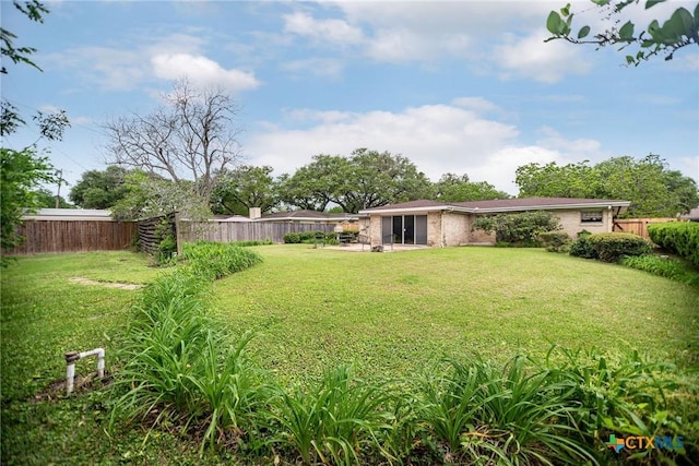 view of yard featuring a patio and a fenced backyard