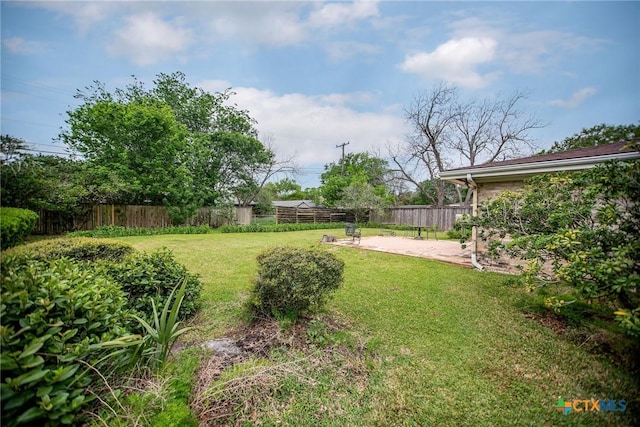 view of yard featuring fence and a patio area