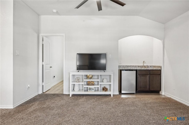 2516 Arno St, Harker Heights, TX 76548 - living area featuring a ceiling fan, light colored carpet, wet bar, arched walkways, and vaulted ceiling